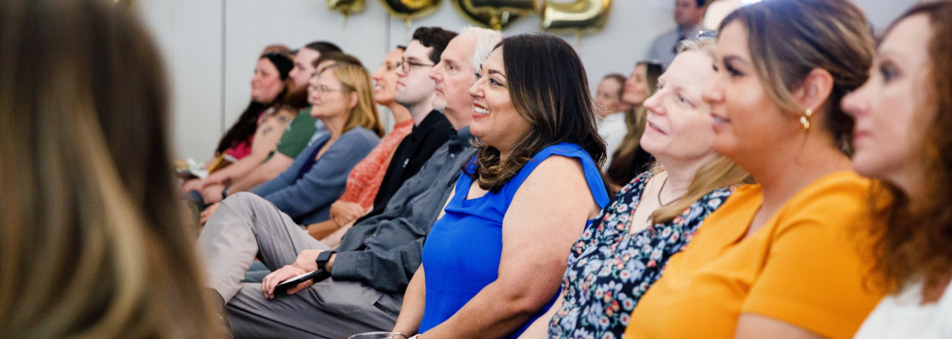 
		Knowledge Enterprise staff smiling while sitting at an awards event		